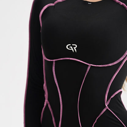 Black athletic outfit with pink accents and a logo on a white background